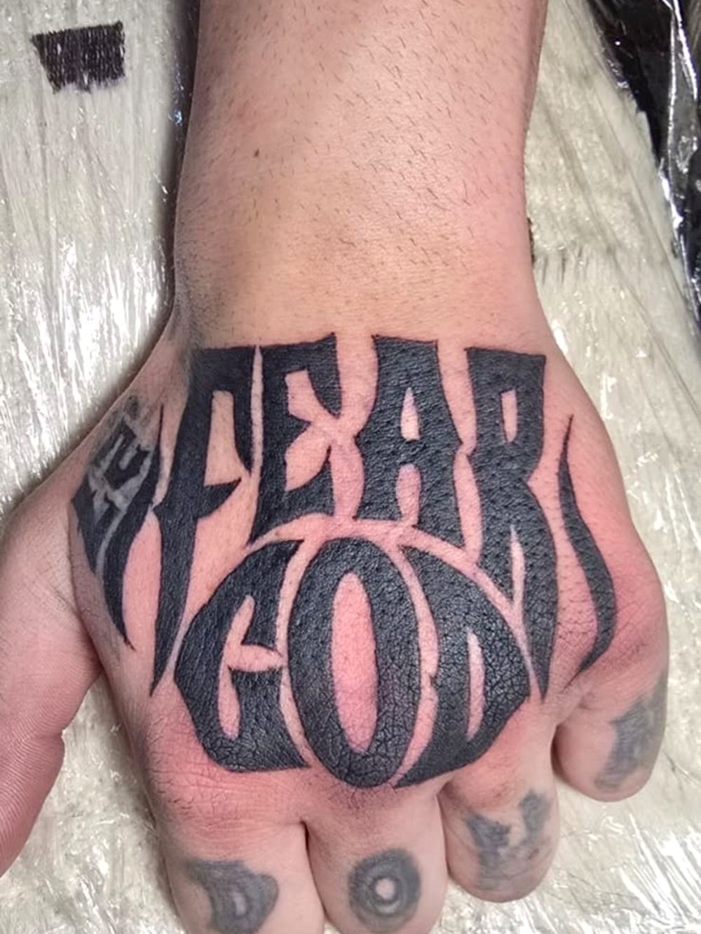 Bold lettering across the hand